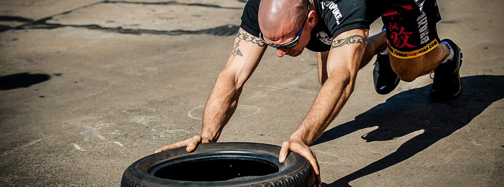 Man pushing a tire