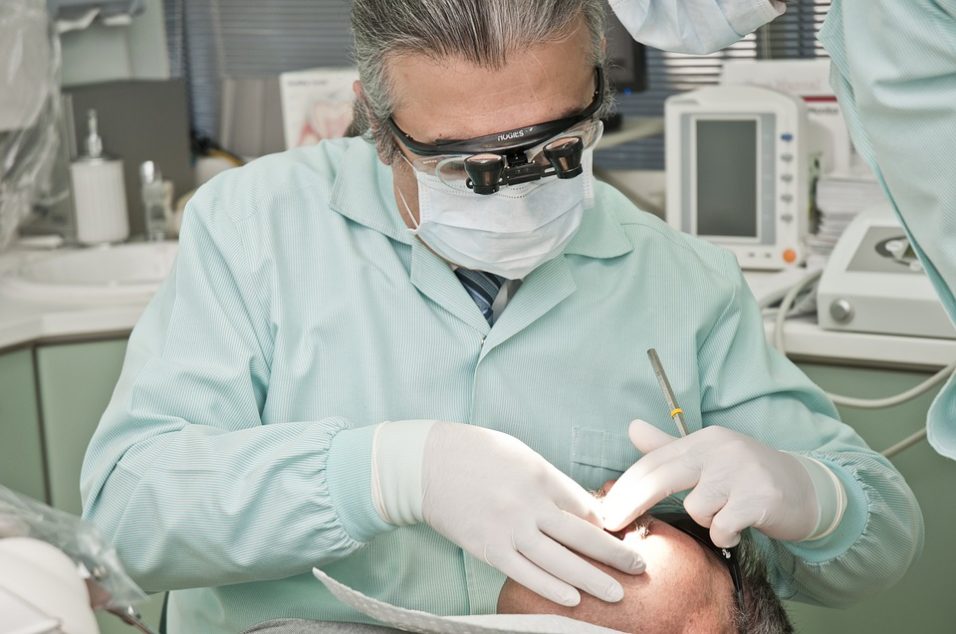 Dentist operating someone